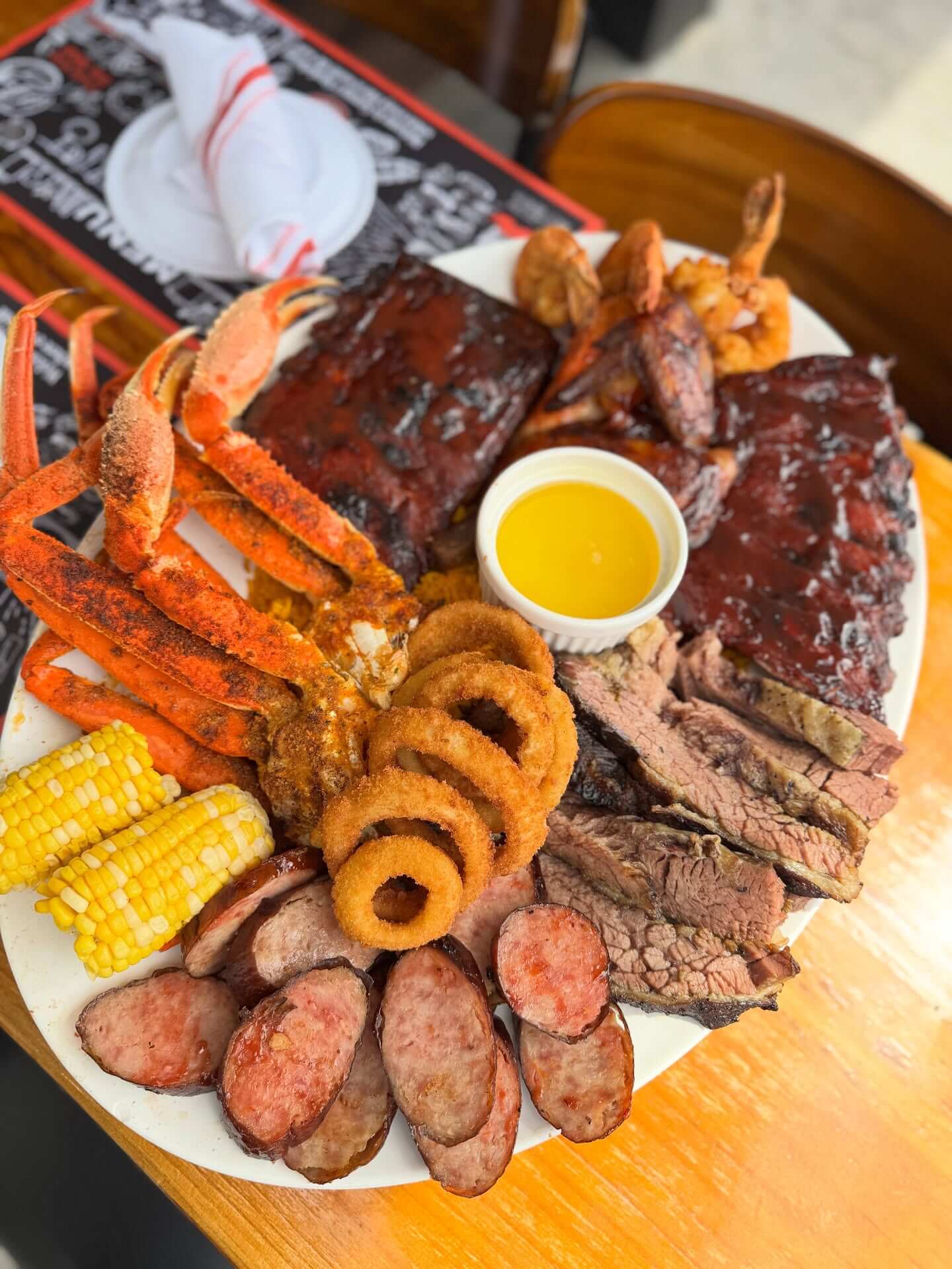 Barbecue and seafood platter with corn and onion rings