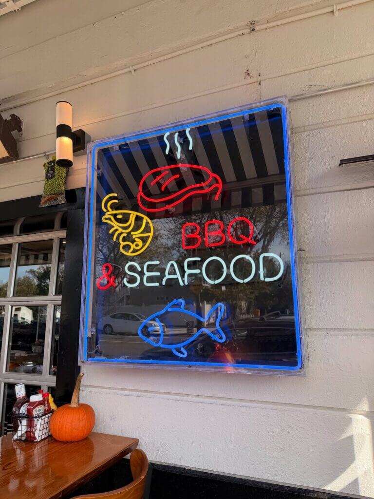 BBQ and seafood neon sign inside Sammy’s Smokehouse